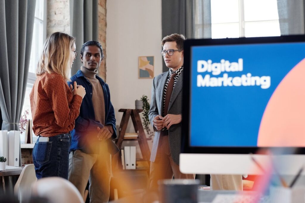 Mastering the First Impression: Your intriguing post title goes here Group of colleagues discussing digital marketing strategies in an office setting.